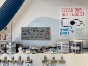 Signs explaining how to properly clean and store ink tubes