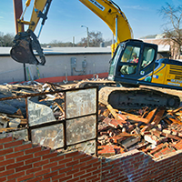 Backhoe doing demolition of a building