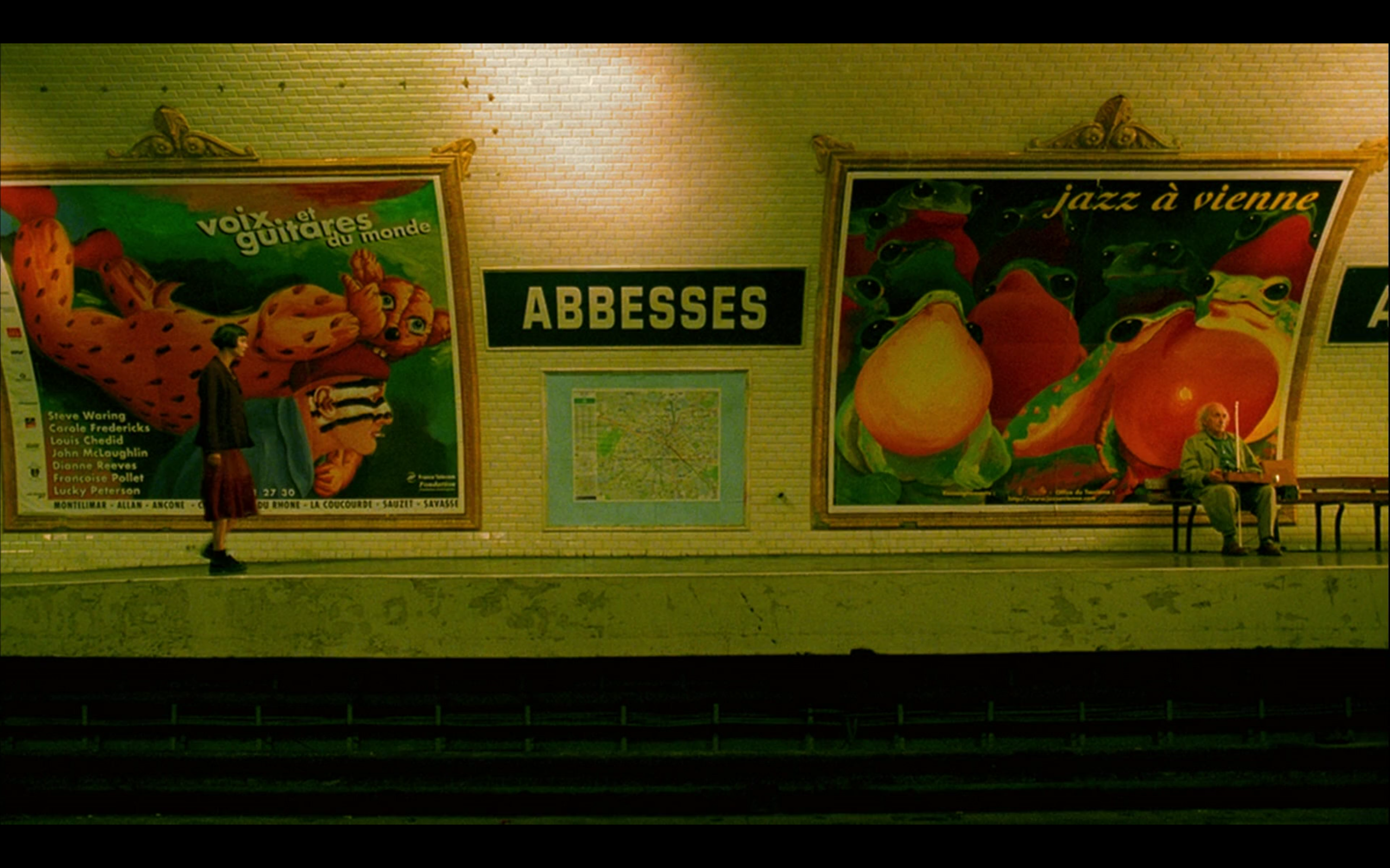 Amélie approaches the poor, blind man on the subway platform.
