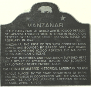 A memorial plaque, located in Manzanar CA, honors the victims of the Japanese internment camps