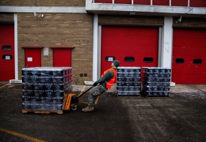 A National Guard Member Hauls Emergency Water // Photo by Sarah Rice for Getty Images