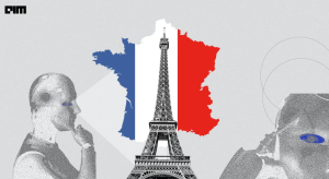 humanoid figure looking at a map of france with the Eiffel Tower in front of it