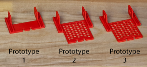 Our first three prototypes for the 3D printed base, showing how it evolved to meet the project's needs while remaining efficient in plastic usage.
