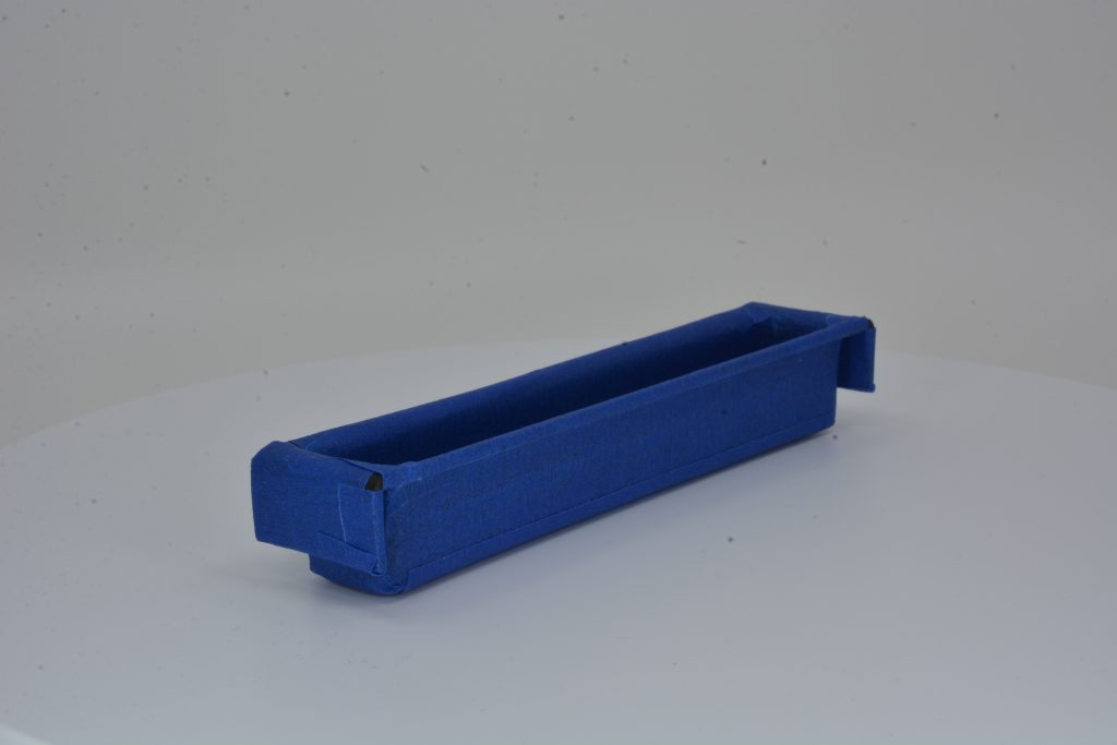 obsolete plastic object coated with blue tape