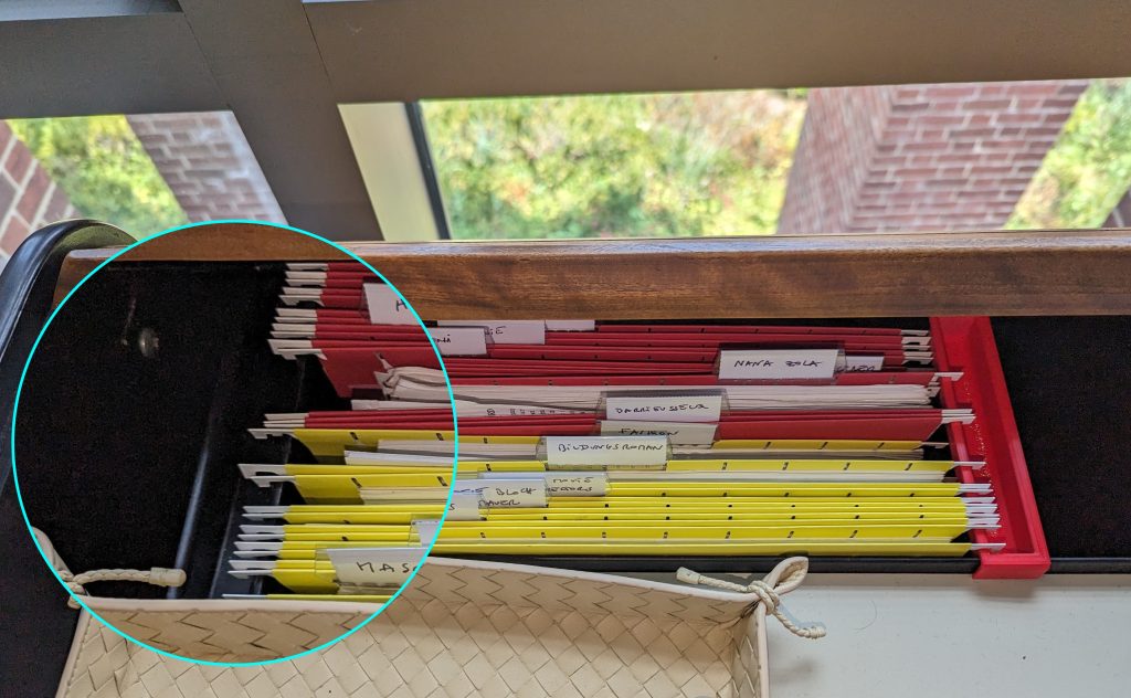 The original black “obsolete plastic object” (on left) keeping files safely stored, alongside the newly cloned red part (on (right)
