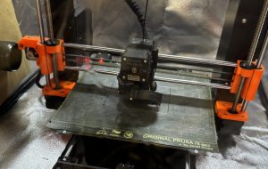 The Prusa i3 (3D Printer) printing the enclosure.