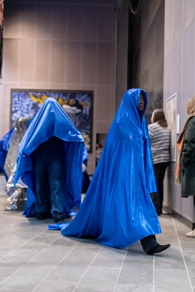 Kusika dancers shroud themselves in fabric for Makonnen’s performance. (Photo courtesy of Brad Wakoff.)