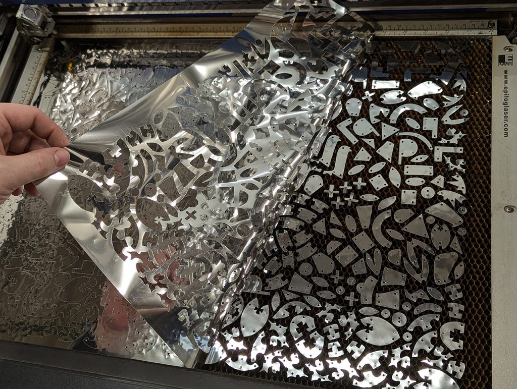 Jason Mativi of the Science Shop uses the Epilog Laser Helix machine to cut mylar for decorating fabric.