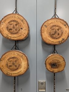 Finished engraved wood appreciations ready to be presented at the Community’s reburial ceremony.
