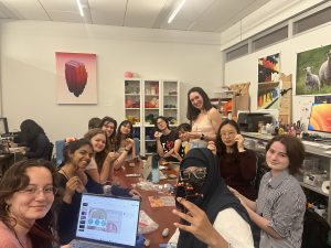 A group of participants in the FabLab working on their wire trees.