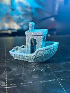 The final look of the 3D Benchy boat after the oxidization process on the copper PLA print.