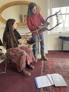 Sabrina Farrell learning to play the lyre with UVM Professor Rachel Fikes.
