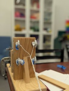 A close-up showing the effects of twisting shrink-wrap and how the individual pieces twine into a four-strand plastic rope.