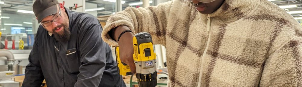 Sam Samuel '26 creating a temporary sled guide to saw logs into planks with bandsaw