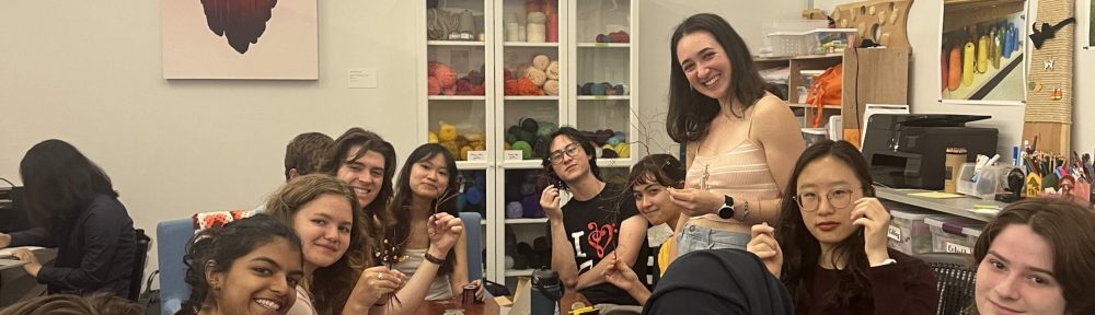 A group of participants in the FabLab working on their wire trees.