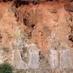 Development of lavaka erosion above and behind roadcut in laterite/saprolite