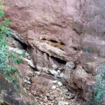 Grottoes form in less-resistant (less quartz-rich) saprolite; blocky debris collects at base