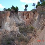 Recent vertical falls indicated by vegetated surfaces within blockfall pile at base of lavaka