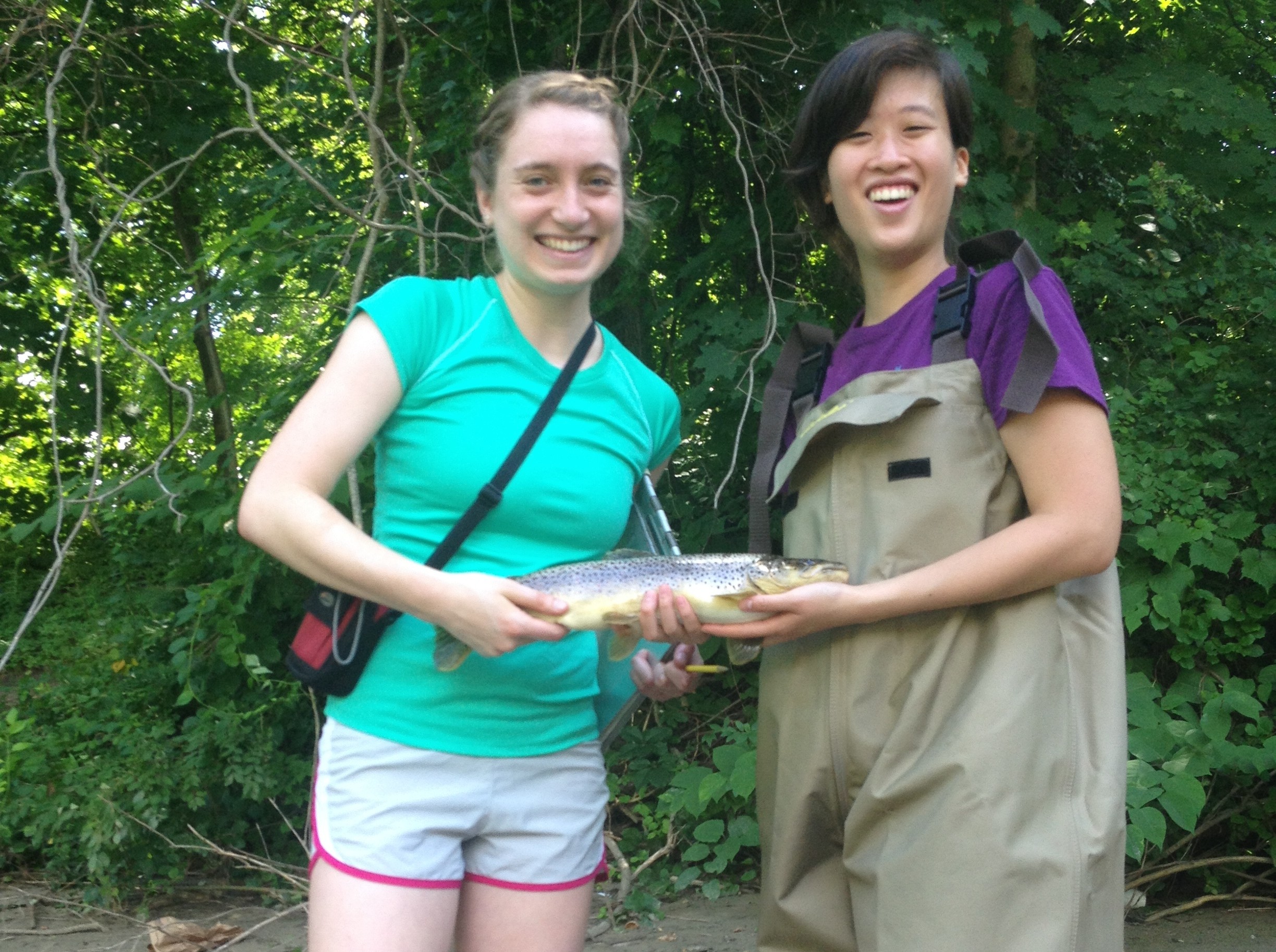 Allie Rowe (left) and Marissa Shieh (right) show off a big catch after electrofishing in the Hoosic River for their summer chemistry research.